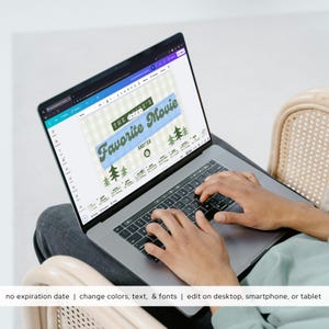 May include: A laptop displaying a design with the text "THE PROB'S Favorite Movie" in a blue and green color scheme. The laptop is open, and the user's hands are on the keyboard. The bottom of the image has the text "no expiration date | change colors, text, & fonts | edit on desktop, smartphone, or tablet."