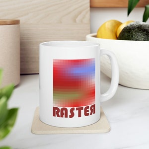 Puede incluir: Taza de cerámica blanca con un diseño pixelado rojo, azul y verde y la palabra "RASTER" en letras rojas.