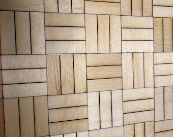 May include: Close-up of a wooden mosaic pattern. The design features rectangular blocks of light-colored wood arranged in a repeating pattern, with thin black lines separating the blocks. The wood grain is visible.