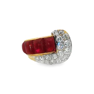 May include: A gold ring featuring a row of four rectangular, deep red rubies set in yellow gold, accented by a curved section of numerous small, round, clear white diamonds set in a bright, polished white metal finish.