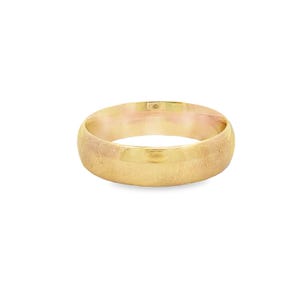 May include: A gold wedding band with a brushed finish. The ring has a rounded shape and a smooth, polished interior. The band is approximately 6mm wide.