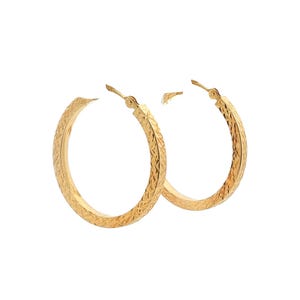May include: A pair of gold hoop earrings featuring a textured, diamond-cut pattern across the surface. The circular earrings have a hinged post closure mechanism at the top, designed to secure the hoop in place when worn on the earlobe.
