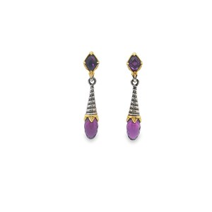 May include: A pair of dangle earrings with a gold and silver design. Each earring features a purple gemstone at the top and bottom, connected by a silver cone-shaped element with gold accents. The earrings are set against a white background.