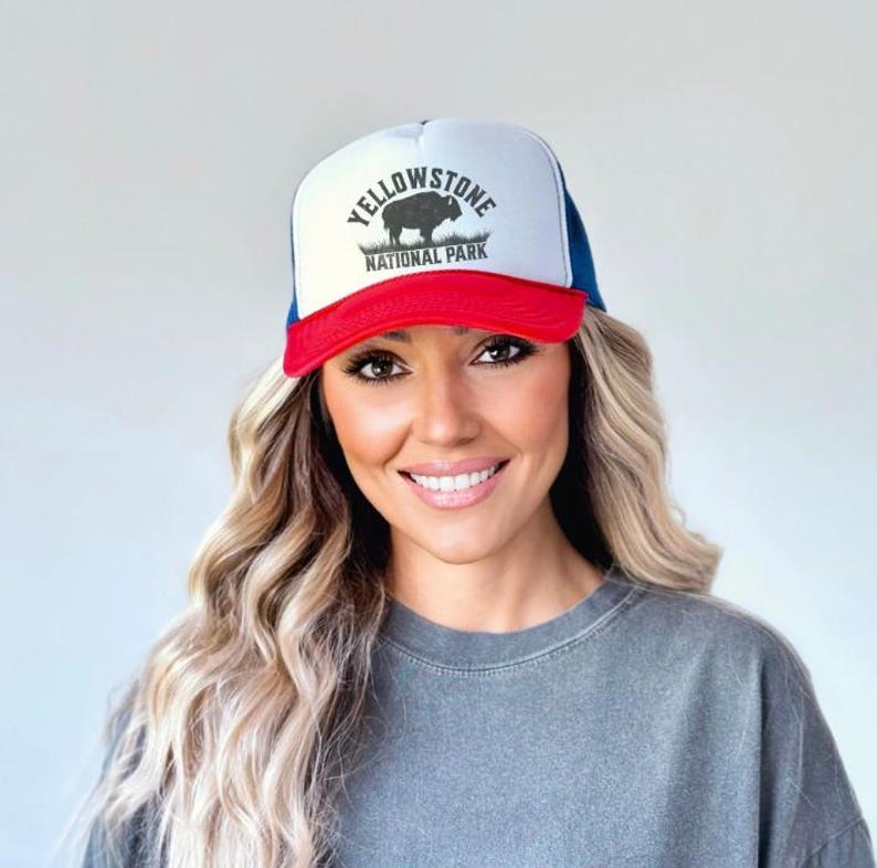 May include: A white, red, and blue trucker hat with a black bison silhouette and the text "Yellowstone National Park".