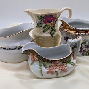 Lot of 4 vintage coffee creamers, saucers,pitchers. Collectable or decorative purpose. Buy one or all. All are in good condition.