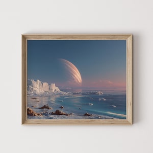 May include: A framed print featuring a surreal landscape with a large planet in the sky. The scene includes a coastline with ice formations, a blue ocean, and a gradient sky with pink and blue hues. The frame is made of light-colored wood.