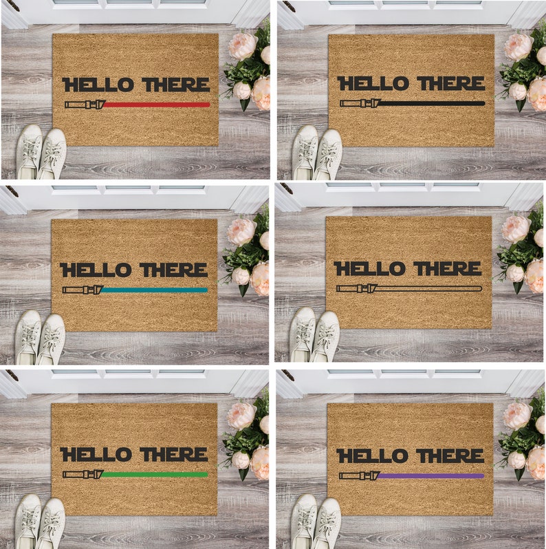 May include: Five doormats with the text "HELLO THERE" and a lightsaber graphic. The doormats are brown and each has a different colored lightsaber: red, black, teal, green, and purple.