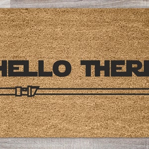 May include: A brown doormat with the text "HELLO THERE" and a black and white lightsaber graphic.