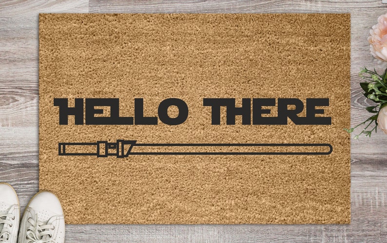 May include: A brown doormat with the text "HELLO THERE" and a black and white lightsaber graphic.