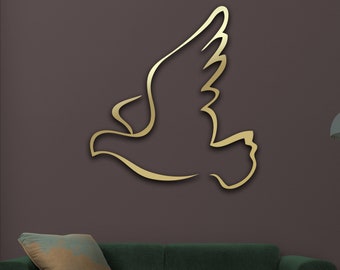 May include: A gold metal wall decor in the shape of a stylized bird, with a green sofa and a floor lamp in the background. The text "Matte Gold" is visible at the bottom of the image.