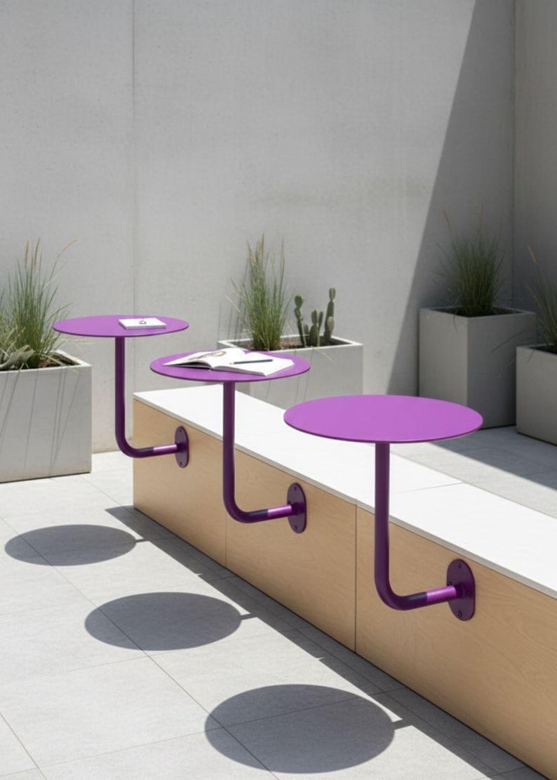 May include: Three purple, round tables attached to a wooden bench. The tables have a curved metal support and are mounted to the bench. The scene is outdoors with potted plants and a light-colored tiled floor.