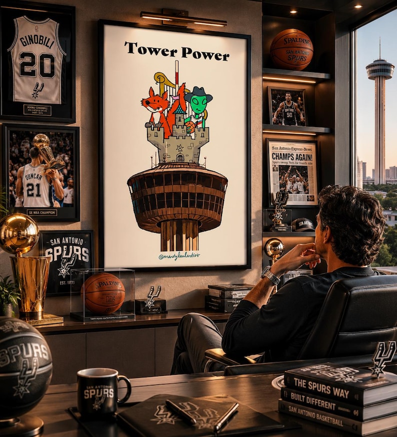 May include: A framed poster titled Tower Power featuring a cartoon illustration of a fox and an alien standing on a stone castle atop a brown tower. The artwork includes a harp and a basketball, set against a white background with a signature.