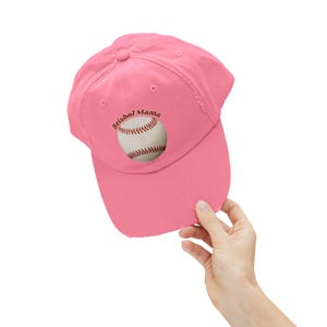 May include: Pink baseball cap with the text "Baseball Mama" and a baseball graphic.