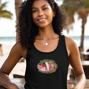 May include: Black tank top featuring a colorful graphic of a Yellowhead Jawfish, with the scientific name Opistognathus Aurifrons. The design is oval-shaped and includes the fish and its habitat. The text is in yellow.