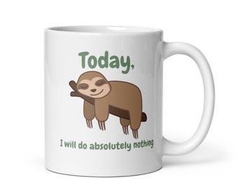 May include: White ceramic coffee mug featuring a cartoon illustration of a brown sloth sleeping on a branch. The text "Today, I will do absolutely nothing" is printed on the mug.