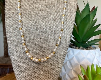 Handmade white glass beads with a smaller gold glass bead