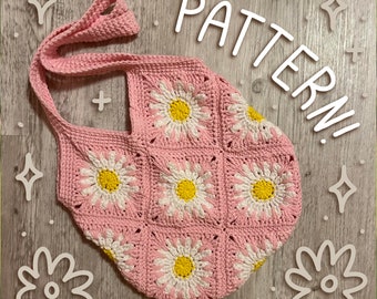 May include: Pink crocheted tote bag with a daisy flower pattern. The bag has a long strap and is made with a chunky yarn.