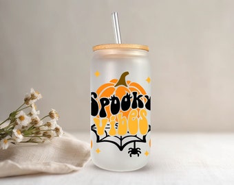 Show off your Halloween spirit with your new Spooky Vibes frosted glass drink cup with bamboo lid on a 16oz Libbey cup