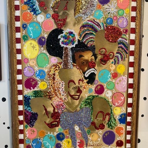 May include: A framed artwork featuring a group of clowns with colorful sequins and glitter. The background is a beige canvas with colorful circles and swirls. The artwork is signed "Robert Quiz".