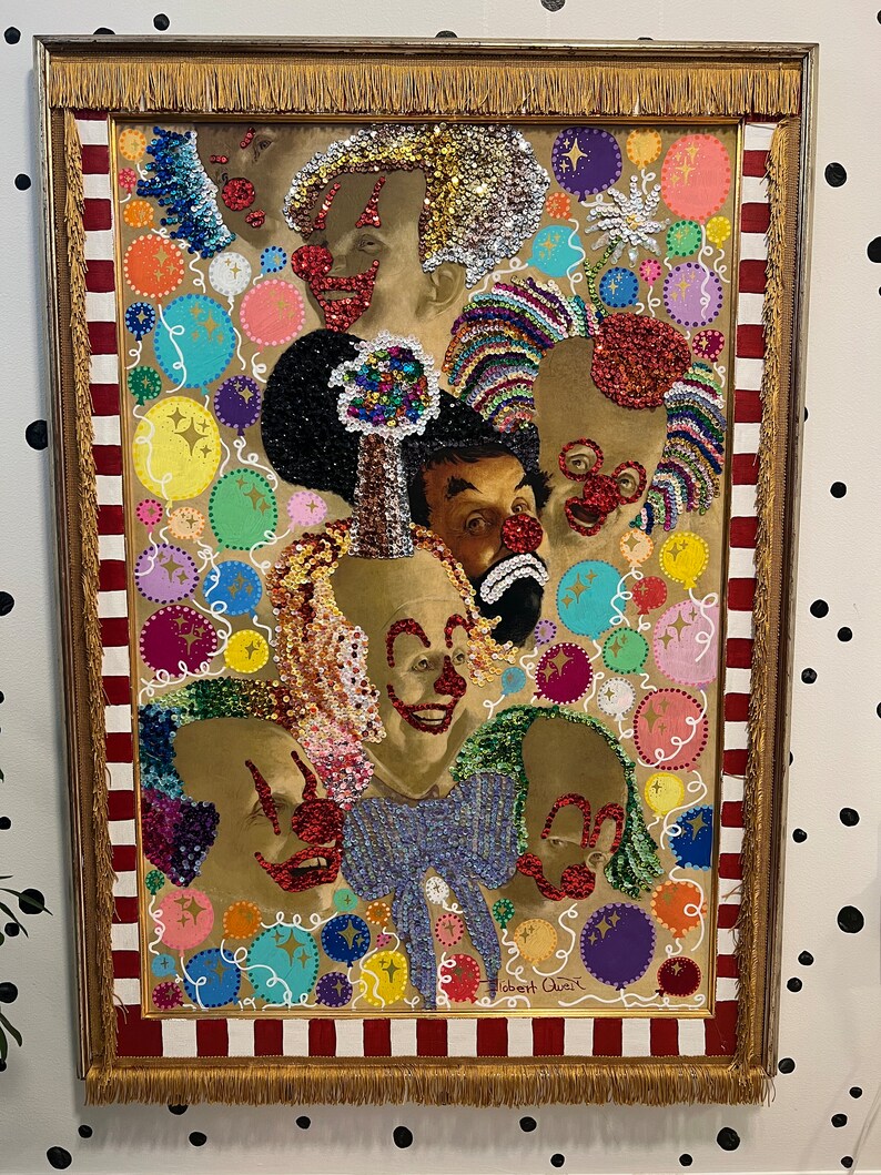 May include: A framed painting of a group of clowns with colorful sequins and glitter. The painting is set against a background of colorful circles and swirls. The painting is signed "Robert Ouimet".