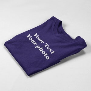 a purple t - shirt with white writing on it