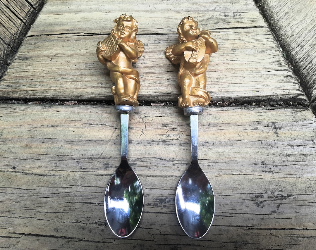Two Stainless Steel Small Serving Spoons W Golden Cherubs Playing