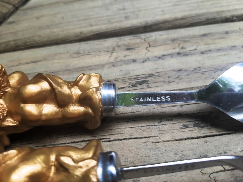 Two Stainless Steel Small Serving Spoons W Golden Cherubs Playing