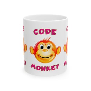 May include: White ceramic mug with a pink and orange design. The mug features a cartoon monkey face with the words "CODE MONKEY" printed on the front.