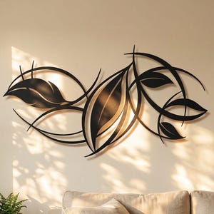 May include: A black metal wall art piece featuring a stylised, horizontal arrangement of interconnected leaves and curved vine-like lines. The design is composed of solid, dark silhouettes that create a flowing, organic pattern across the wall.