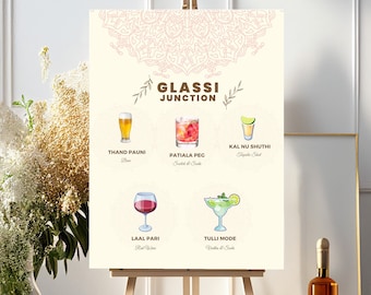 May include: A sign with a light brown background and a pink mandala design at the top. The sign lists four different drinks with illustrations of each drink. The drinks are: Thand Pauni, Patiala Peg, Kal Nu Shuthi, and Tulli Mode. The sign says "Glasi Junction" at the top.