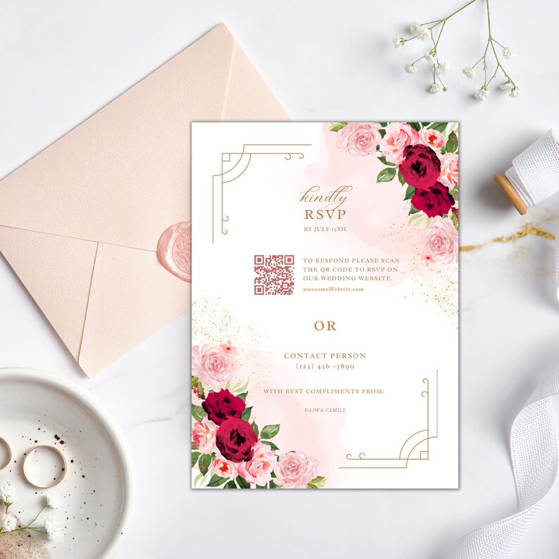 May include: A white RSVP card with a gold border and floral design. The card includes a QR code and instructions to RSVP online or by phone. The text reads "kindly RSVP by July 1st. To respond please scan the QR code to RSVP on our wedding website. www.weddingwebsite.com OR Contact Person (123) 456-7890 With best compliments from: Bajwa Family"