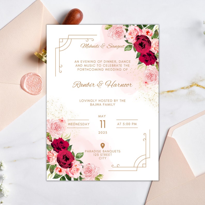 May include: A pink and white floral wedding invitation with gold accents. The invitation is for a Mehndi & Sangeet celebration for Ranbir & Harnoor, hosted by the Bajwa family. The event will take place on Wednesday, 11 May 2023 at 5:00 PM at Paradise Banquets, 123 Street, City.