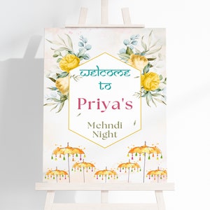 Pode incluir: Placa de boas-vindas à noite de Mehndi de Priya com decorações florais e guarda-chuvas amarelos. A placa está em um cavalete.