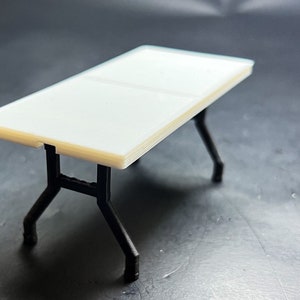 1:18 scale version of a 6&#39; White Table with Foldable Legs.