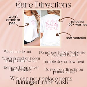 May include: A white t-shirt featuring pink graphic prints on the front and back. The front shows small text, while the back displays various wedding-themed icons and the text Future Mrs. Johnson. Care instructions are listed below the images.