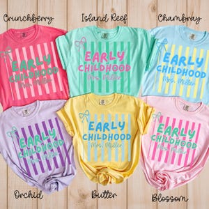 May include: Six colorful t-shirts with the text "EARLY CHILDHOOD Mrs. Miller" and vertical striped designs. Colors include pink, teal, light blue, lavender, yellow, and light pink. Each shirt has a bow graphic.