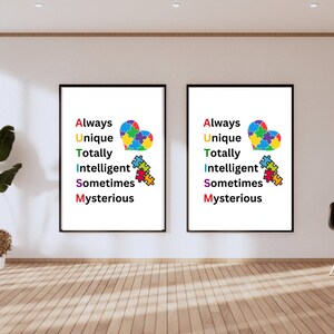 Puede incluir: Dos impresiones enmarcadas con marcos negros y fondos blancos. Cada impresión presenta un corazón de pieza de rompecabezas colorido con el texto "Always Unique Totally Intelligent Sometimes Mysterious" escrito verticalmente en colores arcoíris.