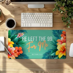 May include: A rectangular teal mousepad with the text "HE LEFT THE 99 For Me" in white and orange, with "MATTHEW 18:12" below. The mousepad is decorated with tropical flowers and leaves.