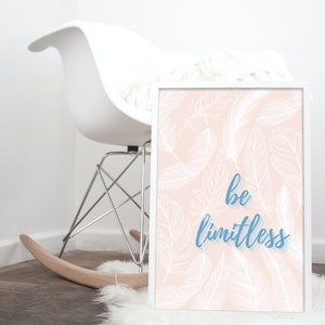 Puede incluir: Una impresión enmarcada en blanco con un fondo rosa y un patrón de plumas blancas. El texto "be limitless" está escrito en azul.