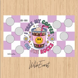 May include: A coffee-themed scratch-off card with a retro design. The card features a cartoon iced coffee cup with a smiley face, the text "I take my coffee on the rocks," and several scratch-off circles on a checkered background.