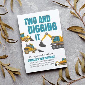 May include: A white invitation card with a blue and yellow construction vehicle theme. The text reads "Two and Digging It" and includes details for Charlie's 2nd birthday party.