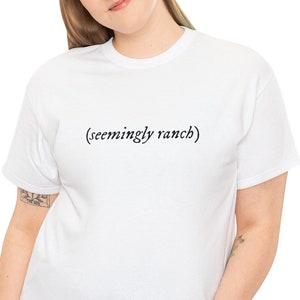 May include: White t-shirt with the text "(seemingly ranch)" printed on the front.