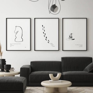 May include: Three black and white framed prints with minimalist line drawings and quotes from the Harry Potter series. The prints are hanging on a white wall above a black sofa.