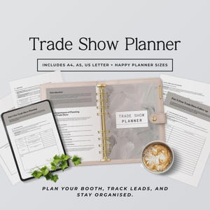 May include: A Trade Show Planner set featuring a ring-bound organizer, loose-leaf pages, and a digital tablet display. The pages include sections for pre-trade show planning and post-trade show follow-up. A small cup of coffee and green leaves are visible.