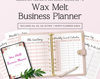 May include: A Wax Melt Business Planner binder with gold rings, open to a Monthly Launch Calendar page. Includes loose-leaf pages for Oils Inventory, Mould Inventory, Expense Log, and Weekly To-Do List. A pen rests on the open planner.