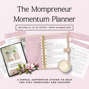 May include: The Mompreneur Momentum Planner set includes a ring-bound planner with a gold mechanism, a tablet displaying the cover, and several loose-leaf pages. The design features soft pink accents, floral imagery, and organized text fields.