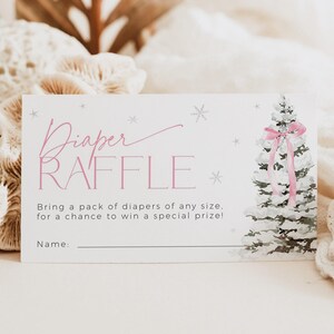 May include: A white card with pink text that says "Diaper Raffle" and a watercolor illustration of a snowy pine tree with a pink ribbon. The text below the title says "Bring a pack of diapers of any size. for a chance to win a special prize!" and "Name:"