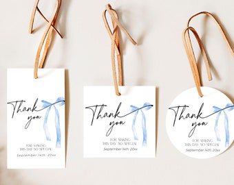 May include: Three thank you tags with blue watercolor ribbon designs. The tags are rectangular and round, with the text "Thank you" and a message about making the day special.