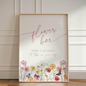 May include: A framed sign with the words "flower bar" in a cursive font. The sign also reads "MAKE A BOUQUET to take on your way" with a floral border featuring colorful flowers and butterflies.