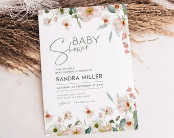May include: A white baby shower invitation with a floral border. The text reads "Baby Shower" in a cursive font. The invitation includes the name "Sandra Miller" and the date and time of the shower.